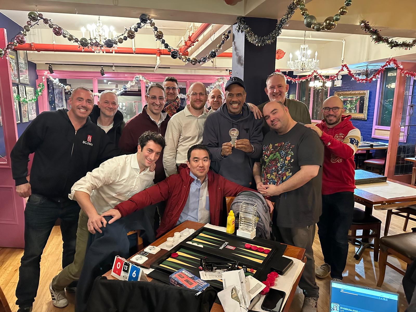 BCGMN members gathered around a backgammon board